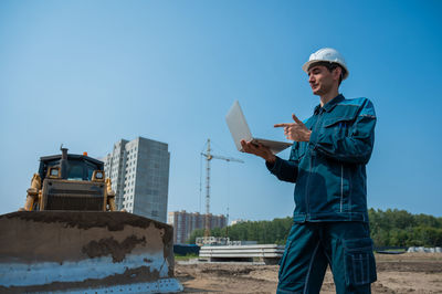 Side view of man working at construction site