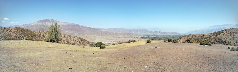 Scenic view of mountains against clear blue sky