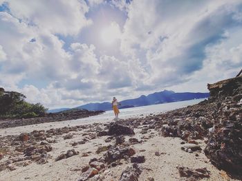 Man standing on beach against sky