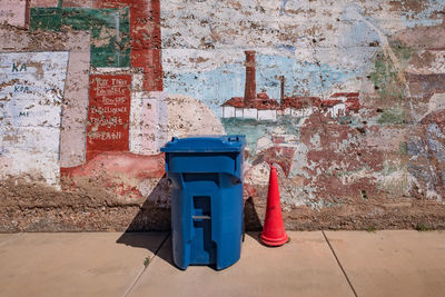 Red umbrella on wall by footpath against building