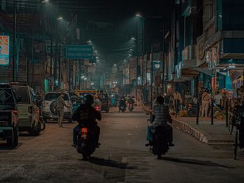 View of people walking on road at night