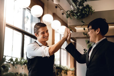 Young man and woman standing at home