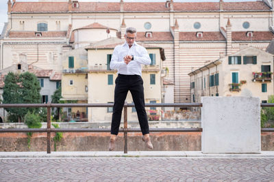 Full length of man holding umbrella