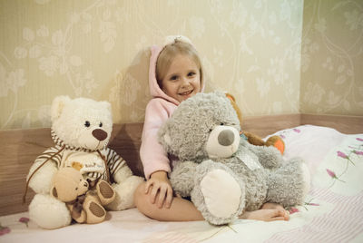 Cute baby girl sitting on sofa