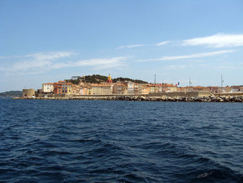 View of sea against buildings in city