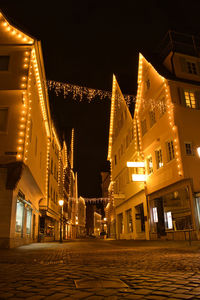 Low angle view of illuminated buildings against sky at night