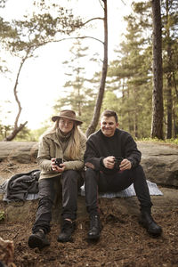 Smiling couple having coffee outdoors