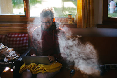 Man sitting on table at home