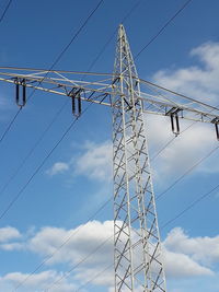 Low angle view of electricity pylon against sky