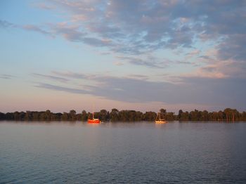 Scenic view of lake against sky during sunset