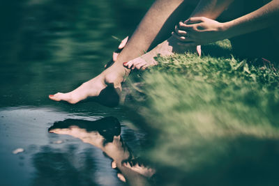 Low section of man swimming in water