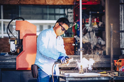 Side view of man working in factory