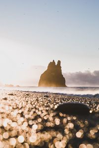 Rocks on beach against sky