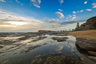 View of beach against cloudy sky