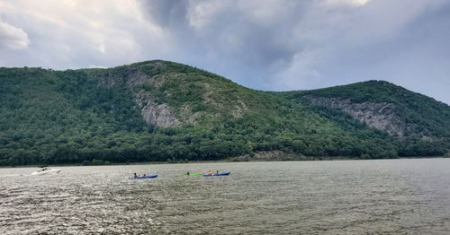 Scenic view of sea and mountains against sky