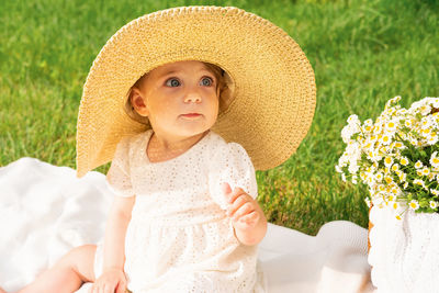 Portrait of young woman wearing hat standing against sky