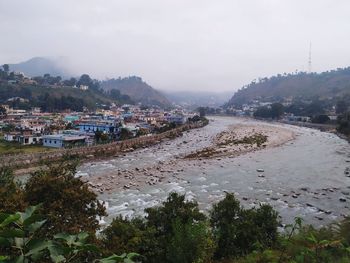 Scenic view of beach and buildings against sky