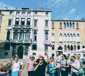 Group of people against building in city