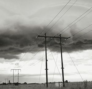 Low angle view of electricity pylon against sky