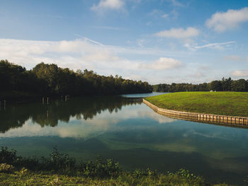 Scenic view of swimming pool by lake against sky