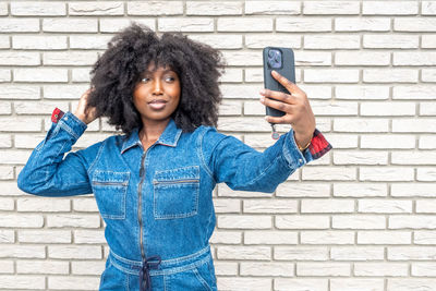 Portrait of smiling young woman using mobile phone