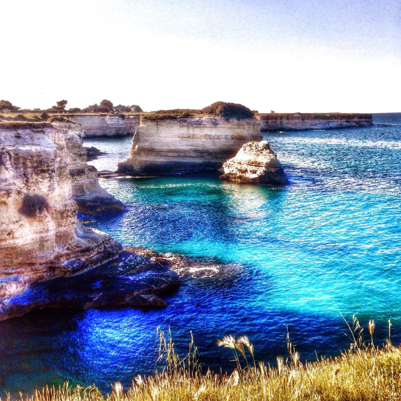 water, sea, tranquil scene, horizon over water, scenics, tranquility, blue, beauty in nature, nature, clear sky, rock - object, idyllic, rock formation, shore, coastline, sky, cliff, beach, rock, rippled