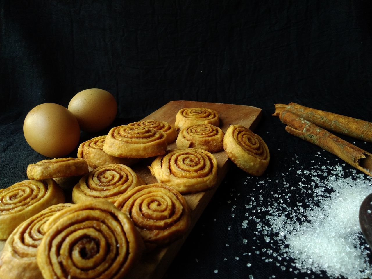 food, food and drink, baked, sweet food, freshness, indoors, snack, no people, cookie, still life, dessert, sweet, flour, wood, high angle view, table, bakery, baked pastry item, dough, black background