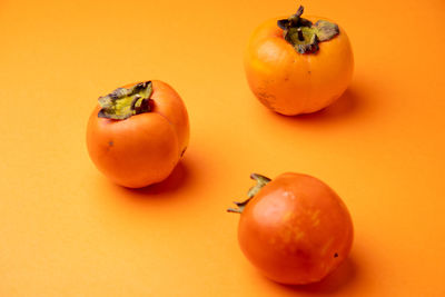 Close-up of tomatoes on orange