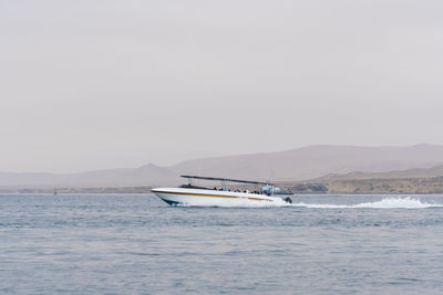 Boat in sea against clear sky