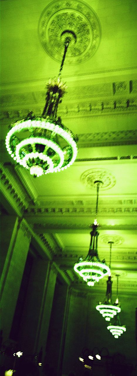 hanging, ceiling, green color, indoors, low angle view, text, lighting equipment, illuminated, no people, communication, architecture, night, close-up