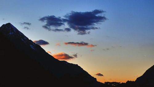 Scenic view of mountains against sky at sunset