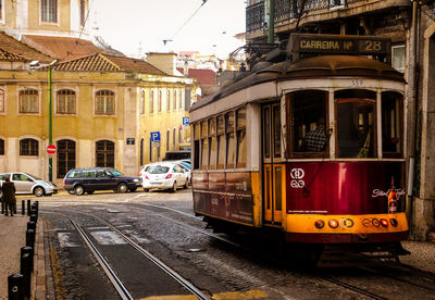 Cars on street by buildings in city