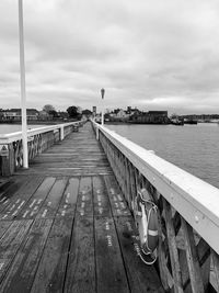 Pier over river against sky