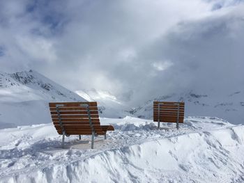 Lifeguard hut on snow covered mountain against sky