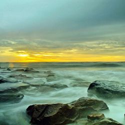 Scenic view of sea at sunset