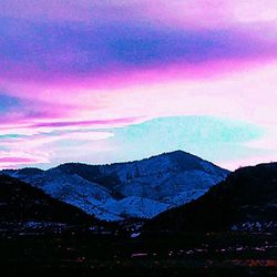 Scenic view of mountains against cloudy sky