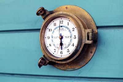 Close-up of clock with text on wall