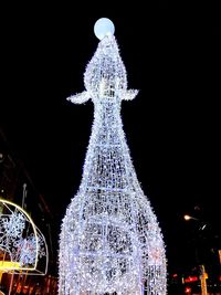 Christmas tree against sky at night