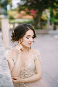 Portrait of young woman standing outdoors