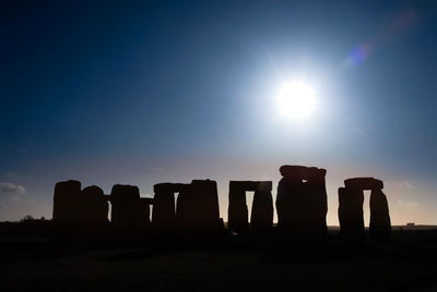 Sun shining through silhouette of historical building