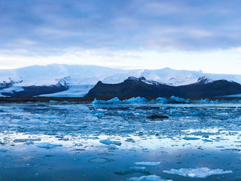 Scenic view of frozen lake against sky