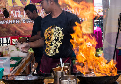 Midsection of man standing at market stall