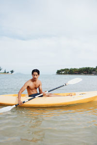 Man kayaking in sea