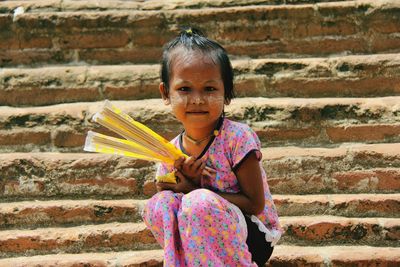 Portrait of girl smiling sitting on steps