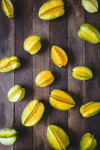 High angle view of starfruits arranged on wooden table