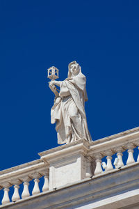 Low angle view of statue against clear blue sky