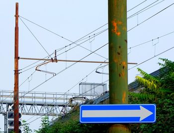 Low angle view of cables against blue sky