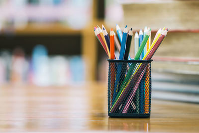 Close-up of multi colored pencils on table