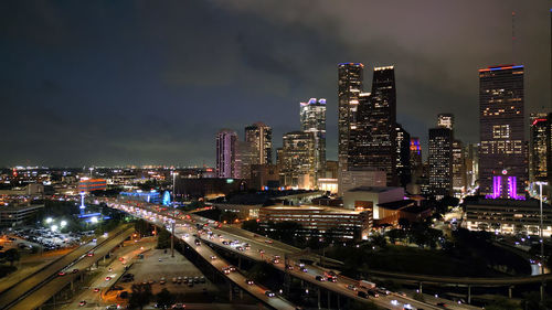 High angle view of illuminated buildings in city at night