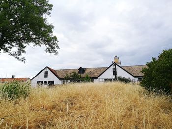 Houses on field against sky